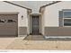 Close up view of the front entrance of a charming home with neutral colors and desert landscaping at 4035 S 176Th Dr, Goodyear, AZ 85338