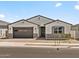Charming single-story home featuring a two-car garage and desert landscaping in a peaceful neighborhood at 4035 S 176Th Dr, Goodyear, AZ 85338