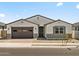 Charming single-story home featuring a two-car garage and desert landscaping in a peaceful neighborhood at 4035 S 176Th Dr, Goodyear, AZ 85338