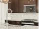Modern kitchen showcasing dark wood cabinets, granite countertops, stainless steel appliances, and a stylish pull-down faucet at 4035 S 176Th Dr, Goodyear, AZ 85338