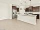 Modern kitchen with stainless steel appliances, granite countertops, a central island, and stylish pendant lights at 4035 S 176Th Dr, Goodyear, AZ 85338