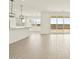Open-concept kitchen and living area with pendant lighting, tile floors, and a sliding glass door to a spacious backyard at 4035 S 176Th Dr, Goodyear, AZ 85338