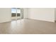 Bright, open living room with modern tile flooring and a sliding glass door leading to the backyard, perfect for entertaining at 4035 S 176Th Dr, Goodyear, AZ 85338