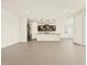 Spacious living room with modern tile flooring that connects to an open kitchen area, creating an inviting and flowing floor plan at 4035 S 176Th Dr, Goodyear, AZ 85338