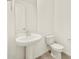 Modern powder room with pedestal sink, toilet, and mirror at 4035 S 176Th Dr, Goodyear, AZ 85338