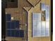 Solar panels on a rooftop for energy efficiency and sustainability, captured from a high-angle aerial view at 42006 W Hillman Dr, Maricopa, AZ 85138