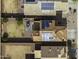 Stunning aerial view of rooftops with solar panels and backyard patio with furniture and mature landscaping at 42006 W Hillman Dr, Maricopa, AZ 85138