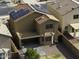 Aerial view of a two-story home with solar panels, a covered patio, and a landscaped backyard at 42006 W Hillman Dr, Maricopa, AZ 85138
