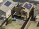 Aerial view showcasing backyard with patio, green space, and house with solar panels at 42006 W Hillman Dr, Maricopa, AZ 85138