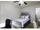 Relaxing bedroom with a decorative silver bed frame, white bedding, and soft, neutral carpet at 42006 W Hillman Dr, Maricopa, AZ 85138
