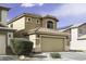Two-story house with a tile roof, two-car garage, and desert landscaping in front yard at 42006 W Hillman Dr, Maricopa, AZ 85138