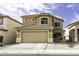 Charming two-story home featuring a tile roof, a two-car garage, and desert landscaping at 42006 W Hillman Dr, Maricopa, AZ 85138