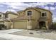 Two-story house with a tile roof, a two-car garage, and desert landscaping in front at 42006 W Hillman Dr, Maricopa, AZ 85138
