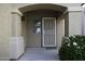 Inviting front porch with stone columns, a security door, and a small window at 42006 W Hillman Dr, Maricopa, AZ 85138