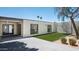 A modern backyard with pavers, synthetic grass, and contemporary design elements offers a private outdoor space at 4336 E Piccadilly Rd, Phoenix, AZ 85018