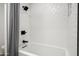 Bright white bathroom featuring a tub/shower combo and modern fixtures at 4336 E Piccadilly Rd, Phoenix, AZ 85018