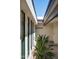 Open carport with desert landscaping, wooden beams, and painted white exterior walls at 4336 E Piccadilly Rd, Phoenix, AZ 85018