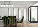 Modern dining area showcasing a stylish light fixture, sleek table, and fashionable olive green chairs at 4336 E Piccadilly Rd, Phoenix, AZ 85018
