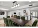 Bright dining room boasts an elegant table with green velvet chairs and modern lighting at 4336 E Piccadilly Rd, Phoenix, AZ 85018
