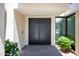 Stylish double doors and lush landscaping create a welcoming entrance to this modern home at 4336 E Piccadilly Rd, Phoenix, AZ 85018