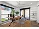 Bright home office featuring a large window, wood desk, neutral decor, and patio door at 4336 E Piccadilly Rd, Phoenix, AZ 85018