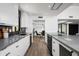 Sleek kitchen featuring stainless steel appliances, white cabinetry, and stone countertops at 4336 E Piccadilly Rd, Phoenix, AZ 85018