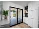 Modern kitchen with black accents, white cabinets, and outdoor access to a wooden deck at 4336 E Piccadilly Rd, Phoenix, AZ 85018