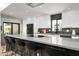 Contemporary kitchen featuring sleek cabinets, marble counters, updated appliances, and bar stool seating at 4336 E Piccadilly Rd, Phoenix, AZ 85018