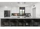The kitchen features modern white cabinetry, marble counters and backsplash, and stainless steel appliances at 4336 E Piccadilly Rd, Phoenix, AZ 85018
