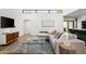 A modern living room featuring hardwood floors, a comfortable sectional, a stylish rug, and a media console at 4336 E Piccadilly Rd, Phoenix, AZ 85018