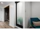 Cozy sitting room with a blue chair and a view of a custom closet with wooden shelving at 4336 E Piccadilly Rd, Phoenix, AZ 85018