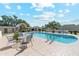 Community swimming pool surrounded by lounge chairs and lush landscaping at 4336 E Piccadilly Rd, Phoenix, AZ 85018