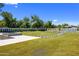 Expansive backyard featuring lush green lawn, privacy landscaping, and a modern outdoor fireplace at 4456 E Earll Dr, Phoenix, AZ 85018