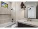 Modern bathroom features a soaking tub, tiled shower, floating vanity with quartz counter, and stylish pendant lighting at 4456 E Earll Dr, Phoenix, AZ 85018