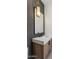 Modern bathroom features sleek floating vanity, stylish lighting, and chic vertical tile accent wall at 4456 E Earll Dr, Phoenix, AZ 85018
