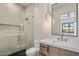 Bathroom features tiled walk-in shower, floating vanity with stone counter, and contemporary pendant lighting at 4456 E Earll Dr, Phoenix, AZ 85018