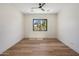 Expansive bedroom with hardwood flooring, recessed lighting, ceiling fan, and a large window at 4456 E Earll Dr, Phoenix, AZ 85018