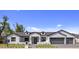 Charming single-story home boasts a white brick facade, gray roof, and meticulously manicured lawn at 4456 E Earll Dr, Phoenix, AZ 85018