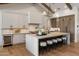 Modern kitchen features an island with seating, white cabinets, and stainless steel appliances at 4456 E Earll Dr, Phoenix, AZ 85018