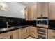 Kitchenette with granite countertops, stainless steel appliances, and custom cabinetry provides functionality and style at 4456 E Earll Dr, Phoenix, AZ 85018