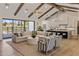 Spacious living room features exposed ceiling beams, modern decor, and seamless flow to the outdoors at 4456 E Earll Dr, Phoenix, AZ 85018