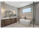 Spa-like bathroom with soaking tub, modern fixtures, and tiled walls at 4456 E Earll Dr, Phoenix, AZ 85018