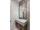Stylish powder room featuring a modern sink and decorative mirror at 4456 E Earll Dr, Phoenix, AZ 85018