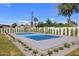 Recreational sport court featuring a vibrant blue surface, surrounded by lush green grass and manicured landscaping at 4456 E Earll Dr, Phoenix, AZ 85018