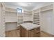 Spacious walk-in closet with custom shelving and center island at 4456 E Earll Dr, Phoenix, AZ 85018