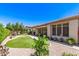 Backyard with covered patio, artificial grass and desert landscaping around perimeter at 4626 E Blue Spruce Ln, Gilbert, AZ 85298