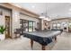 Billiards room with pool tables, comfortable seating, and neutral decor for a fun time at 4626 E Blue Spruce Ln, Gilbert, AZ 85298