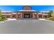 Inviting clubhouse entrance with stone pillars and covered entry for gathering with friends at 4626 E Blue Spruce Ln, Gilbert, AZ 85298