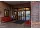 Clubhouse entrance with sitting area and signage for member services, cafe, and other community offerings at 4626 E Blue Spruce Ln, Gilbert, AZ 85298