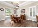 Elegant dining room with a round table set, wood floors, and ample natural light at 4626 E Blue Spruce Ln, Gilbert, AZ 85298